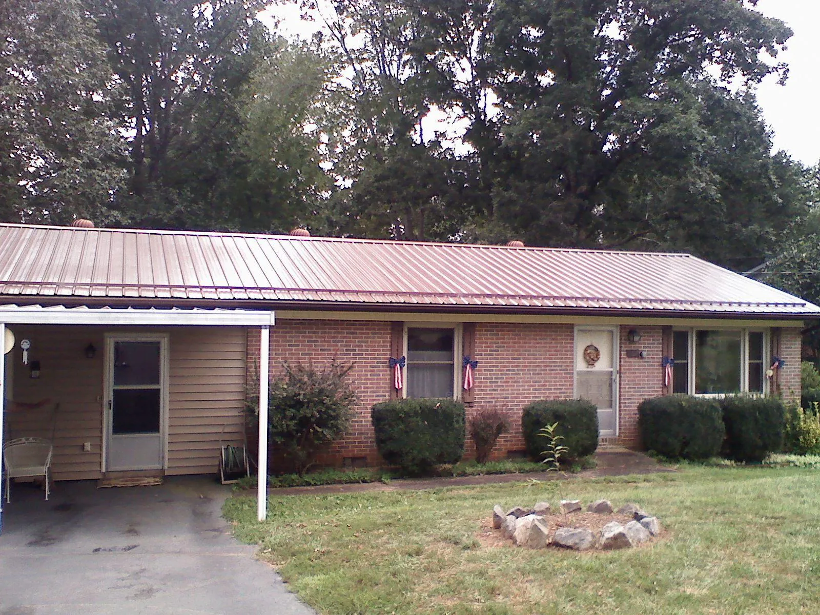 Bronze metal roof and carport on a brick ranch home — Roof Repair work by our crew in San Bruno