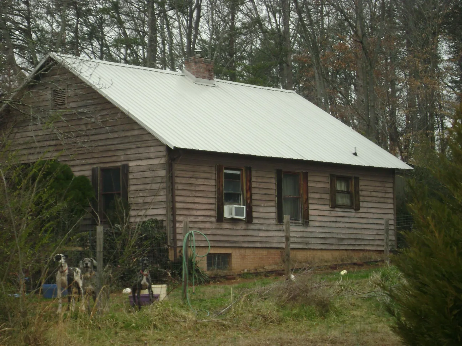 White metal roof on an old wood sided farmhouse, from a Asphalt Shingle Roof Repair job in San Bruno